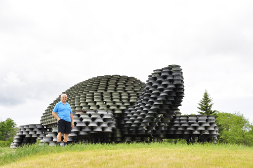 Lee Duquette with the "World's largest man-made turtle" in Dunseith, North Dakota